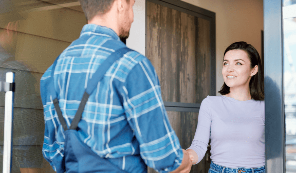 Home services employee shaking hands with a customer